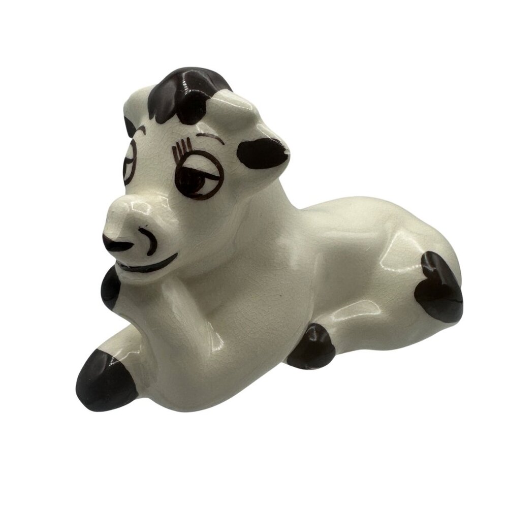 Ceramic Cow Figurine With Brown Spots & Playful Expression